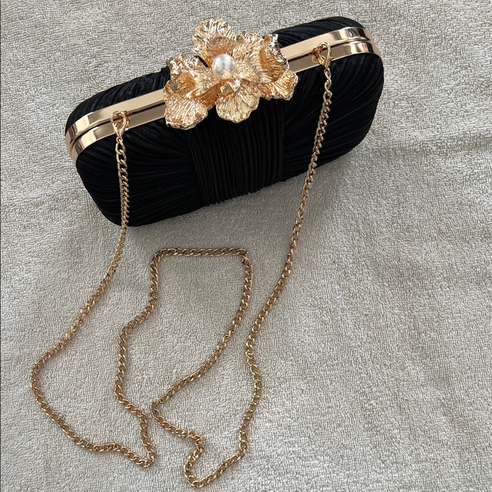 Elegant Black and Gold Clutch with Floral Accent